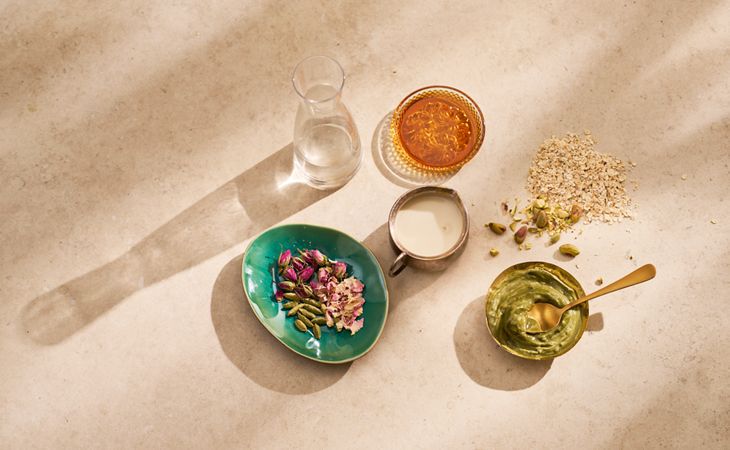 Ingredients for pistachio coconut overnight oats recipe, including oats, spices, and milk.